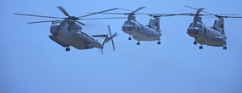 three large military helicopters in flight